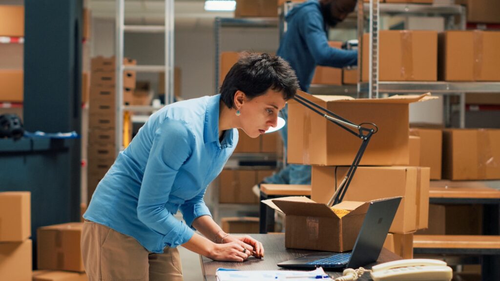 Business owner working on supply chain management and distribution, quality control at a warehouse.