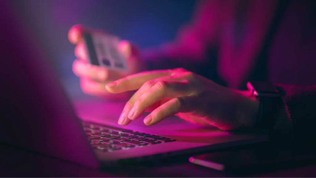 A woman entering a cyber password on a personal laptop